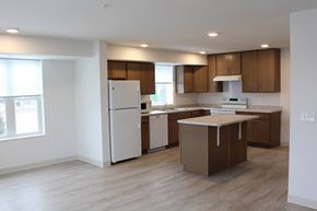 Carver apartment for rent - A kitchen with brown cabinets and a white fridge.