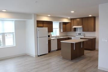 Carver apartment for rent - A kitchen with brown cabinets and a white fridge.