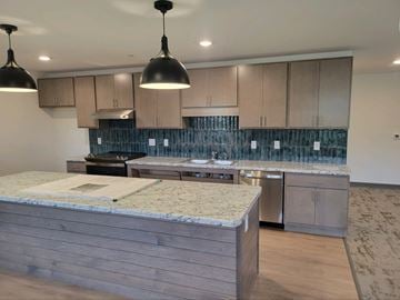 Waconia apartment for rent - a kitchen with stainless steel appliances and marble counter tops