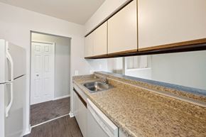 Flint apartment for rent - a kitchen with granite counter tops and a stainless steel sink