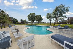 Flint apartment for rent - a pool and lounge area with furniture around it