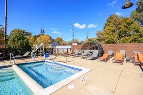 Ann Arbor apartment for rent - A swimming pool surrounded by chairs and trees.
