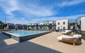 Fort Wayne apartment for rent - A pool area with a sun lounger and a building in the background.
