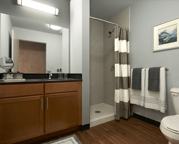 Oversized showers with subway tile surrounds and spacious bathroom vanities