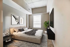 Fort Wayne apartment for rent - A bedroom with a bed, a nightstand, a plant, and a TV.