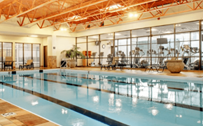 Cleveland apartment for rent - A large indoor swimming pool with a glass wall on one side.