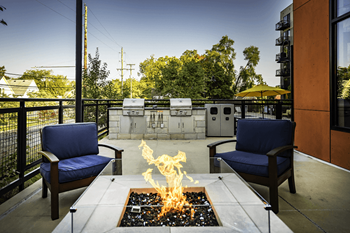 Outdoor lounge areas with custom fire pits and grilling station