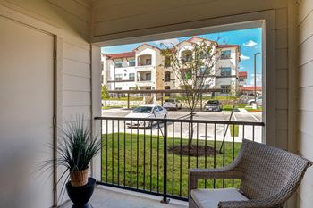 Covered patio overlooking street and apartment building