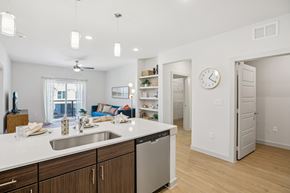 Kyle apartment for rent - A kitchen with a white counter top and wooden cabinets. at ThreeTwenty at the Vybe Apartments, Texas, 78640