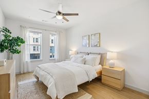 Kyle apartment for rent - A bedroom with a large bed and a ceiling fan. at ThreeTwenty at the Vybe Apartments, Kyle, Texas