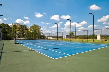 Tennis court with blue surface and lighting