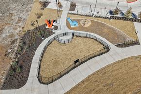 Kyle apartment for rent - A playground with a blue and white slide and a red and white slide. at ThreeTwenty at the Vybe Apartments, Kyle, TX, 78640