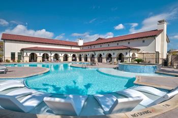 Resort style pool with spanish architecture clubhouse