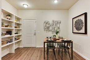 Del Valle apartment for rent - Dining room with builtin shelving and decorative wall piece at Eastridge Apartments, Texas