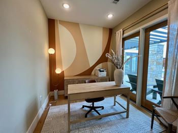 A room with a desk and a chair.
