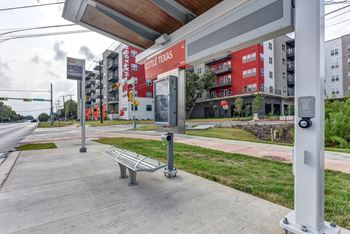 Bus stop shelter near apartment community entrance