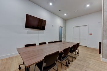 Conference room with large table and wall mounted tv