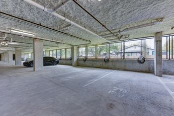 Covered parking garage with concrete columns and windows 1