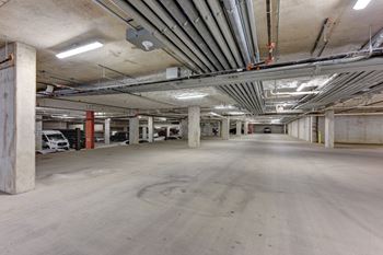 Underground parking garage with concrete columns and exposed utilities