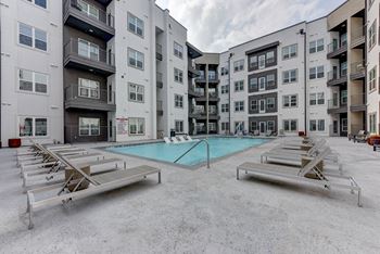 Swimming pool with lounge chairs in courtyard
