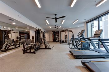 Fitness center with cardio and strength training equipment 1