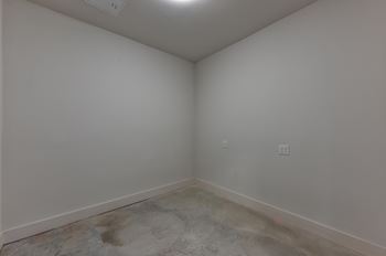 Empty room with concrete flooring and electrical outlets