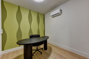 Office space with curved desk and rolling chair