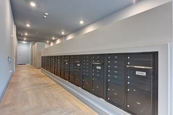 Mail room with bronze mailboxes along wall