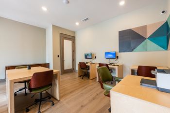 A room with two computers and three chairs