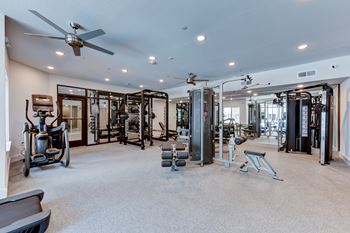 A spacious home gym with a variety of exercise equipment.