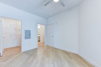 A room with a white ceiling and a wooden floor.