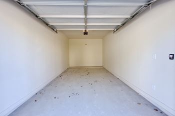 A long, empty hallway with a white ceiling and walls.