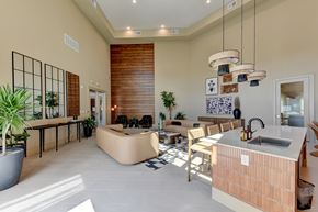 Manor apartment for rent - A modern kitchen with a wooden island and a dining table with chairs.
