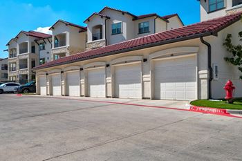 Row of private garages with red tile roofing