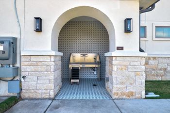 Outdoor grilling area with arched tile alcove