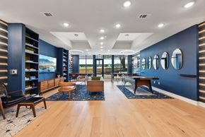 Austin apartment for rent - Clubhouse lounge with blue walls and mirrors at Bridge at Windsor Park Apartments, Austin