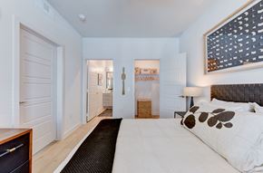 Austin apartment for rent - A bedroom with a large bed and a painting on the wall. at Park South Apartments, Austin, TX