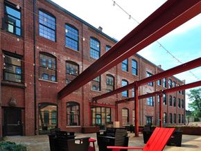 Baltimore apartment for rent - A red brick building with a red ramp in front.