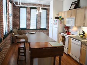Baltimore apartment for rent - A kitchen with a table and chairs in front of a window.