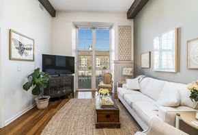 Baltimore apartment for rent - A living room with a white couch and a television.