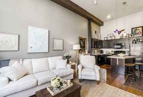 Baltimore apartment for rent - A living room with a white couch and a coffee table with flowers on it.