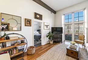 Baltimore apartment for rent - A living room with a large window and a flat screen TV.