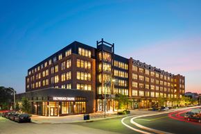 Baltimore apartment for rent - Howard Bank building with cars parked in front.
