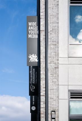 Baltimore apartment for rent - A tall building with a sign that says Wide Angle Youth Media.