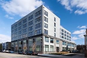 Baltimore apartment for rent - A modern building with a glass facade and a sign that reads "The Service Center.".