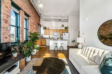 Baltimore apartment for rent - A living room with a white couch and a wooden coffee table.