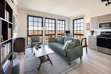 Baltimore apartment for rent - A living room with a green couch and a coffee table.
