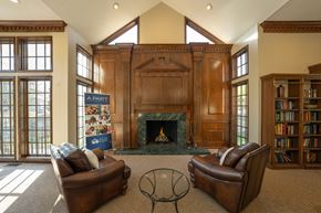 Farmington Hills apartment for rent - A living room with a fireplace and two leather chairs.