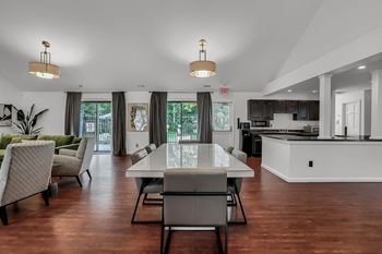 A kitchen and living room with a table and chairs