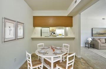 Grand Blanc apartment for rent - a dining area with a table and chairs and a kitchen in the background